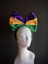 Mardi Gras headpiece featuring a large sequined bow in purple, gold, and green, accented with green netting for a vibrant, festive look.