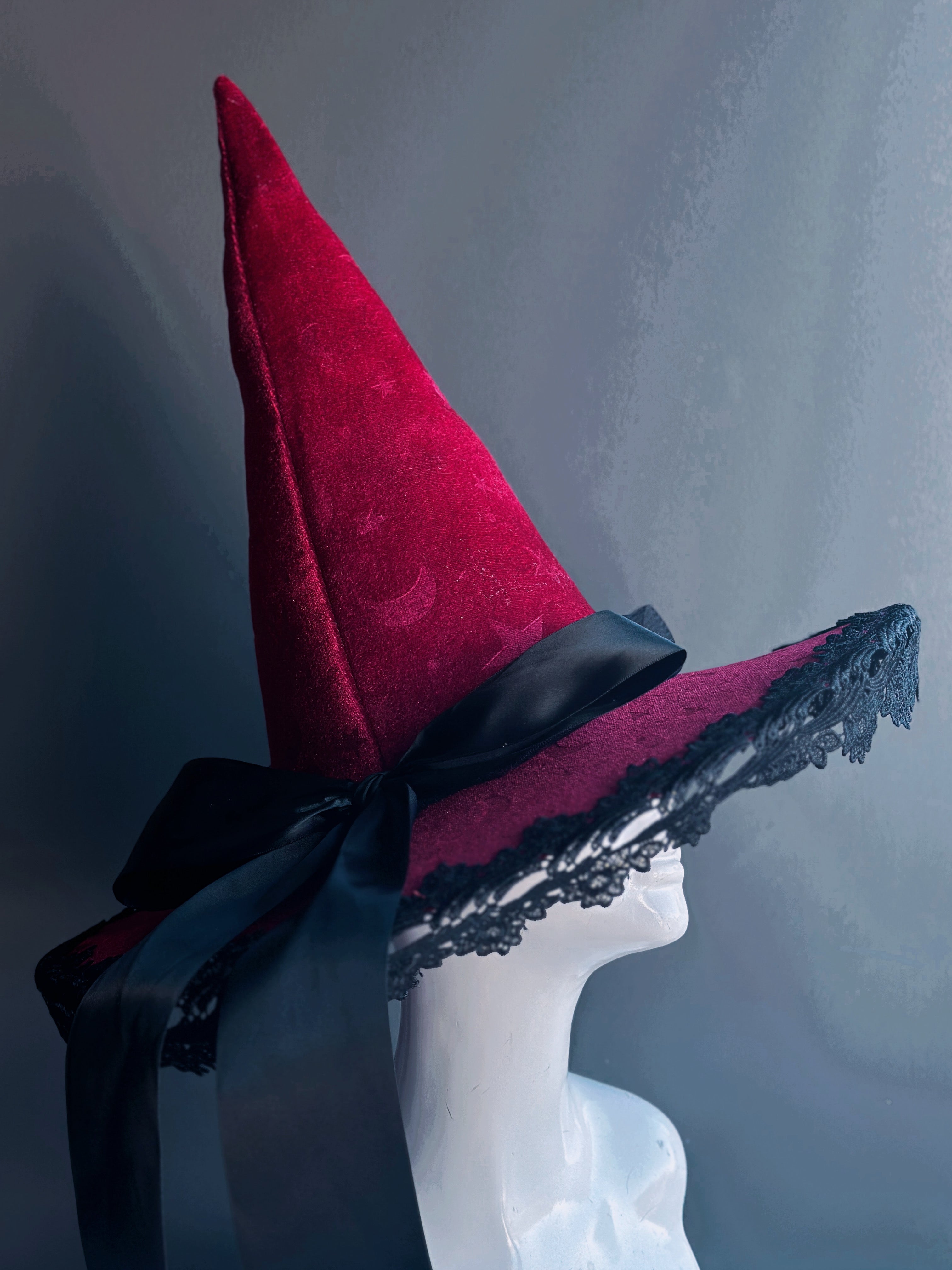 Masquerade Store celestial witch hat with stars and moons design in velvet with black lace and satin ribbon, available in deep crimson, white, and black