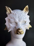 Wolf masquerade mask in white with golden ears and snout.