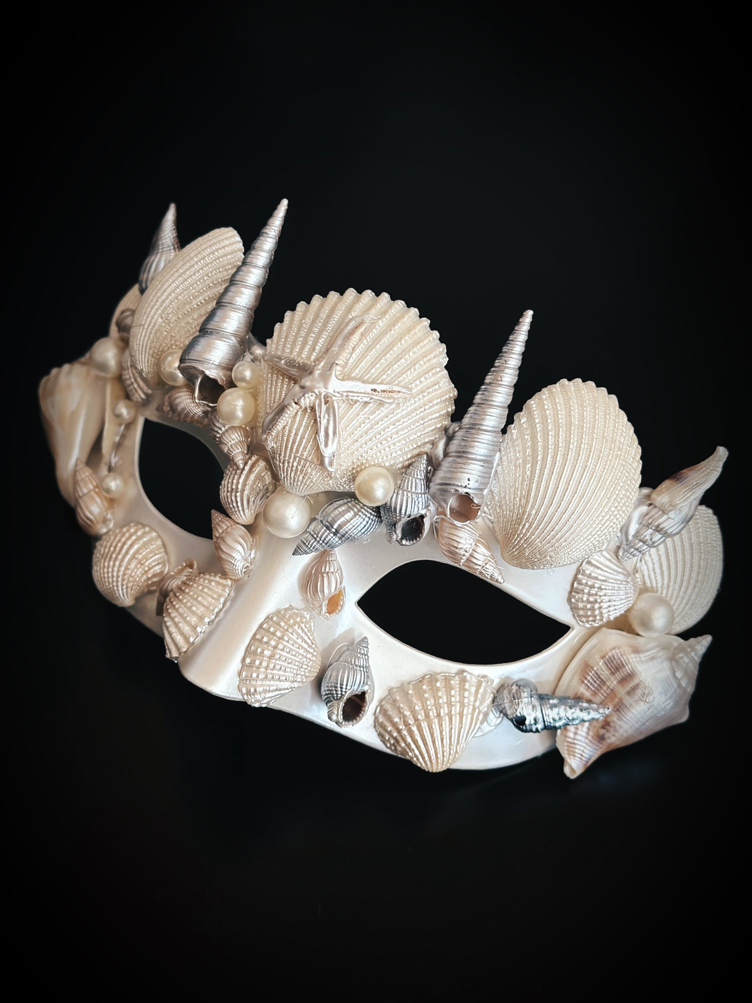 Mermaid masquerade mask in ivory with seashells, pearls, and starfish for ocean-themed events.