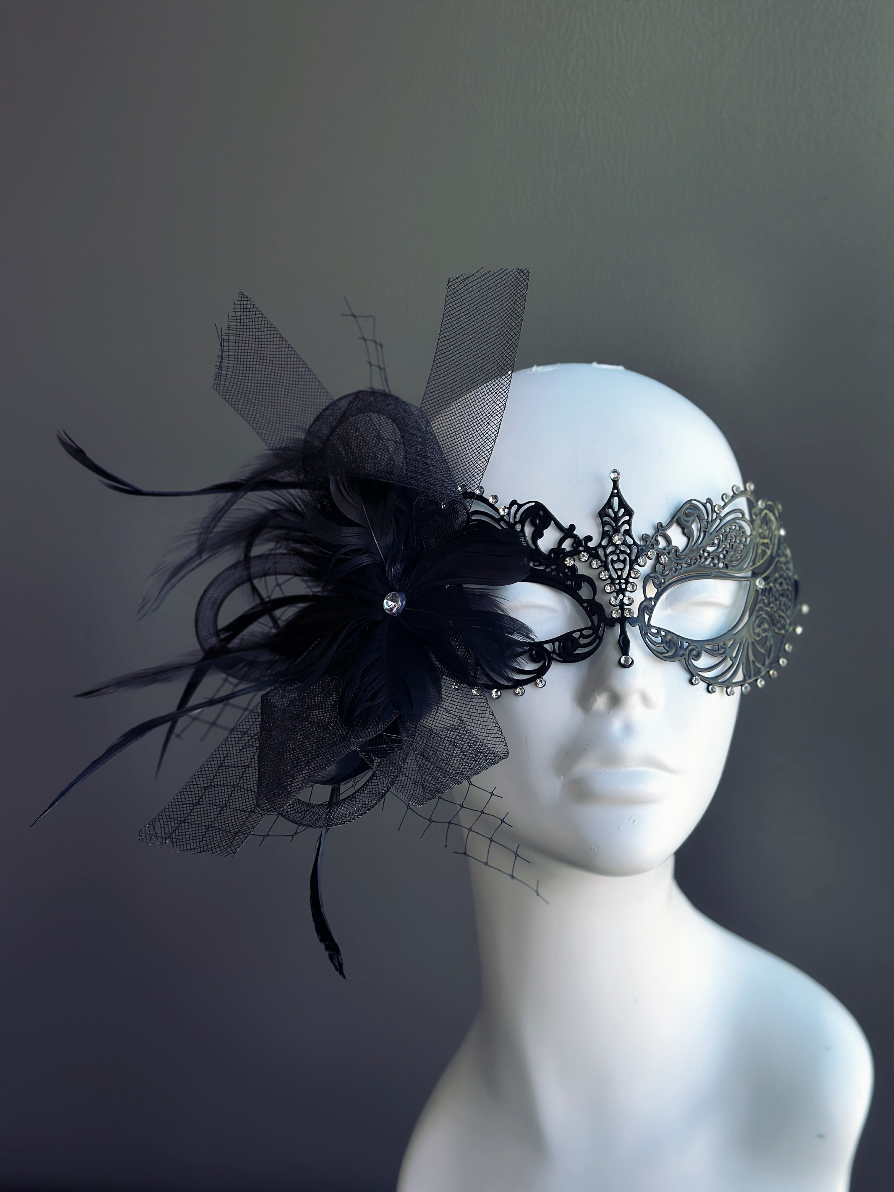 black metal mask with rhinestones and black feathers