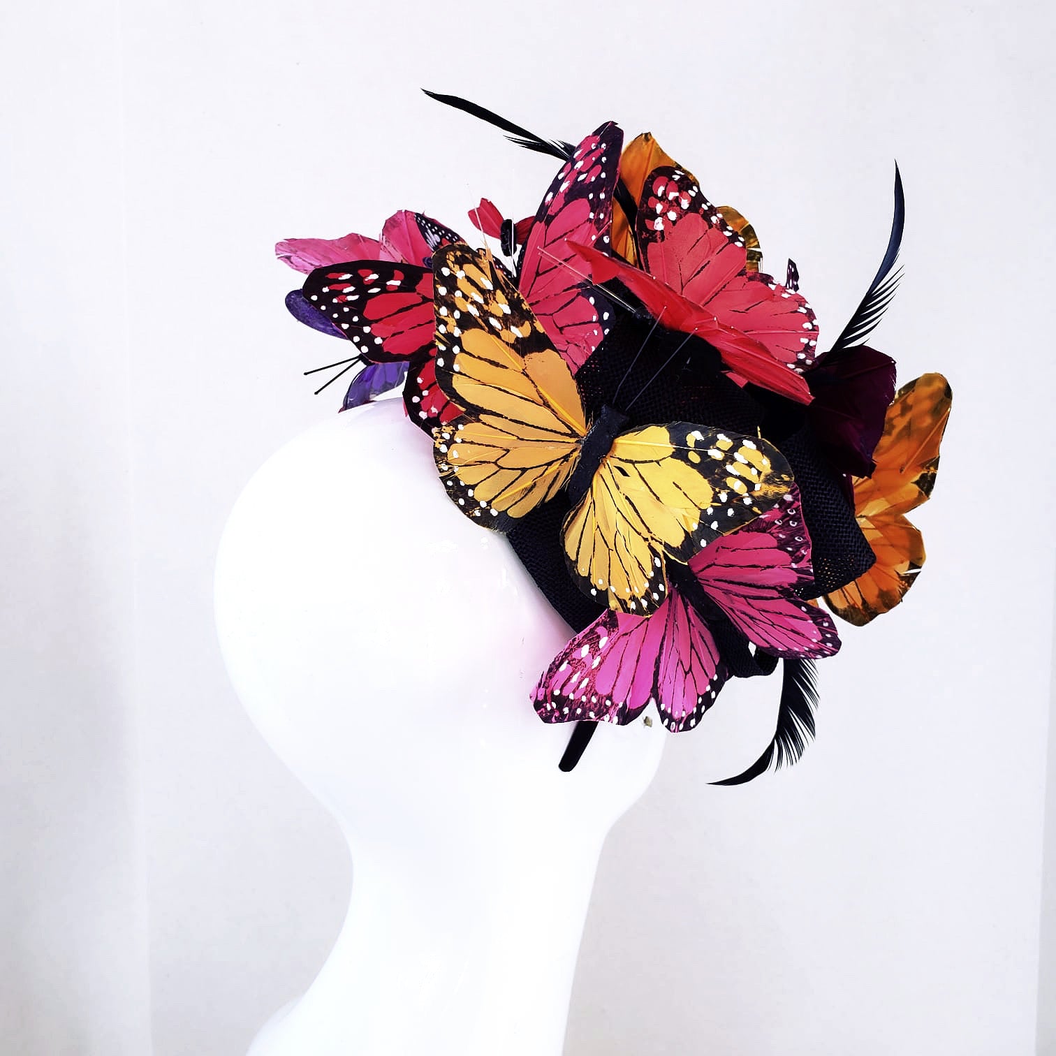Multicolor butterfly fascinator headpiece with pink, yellow, and red butterflies