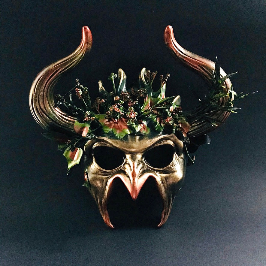 Nature-inspired masquerade mask with horned design and floral accents