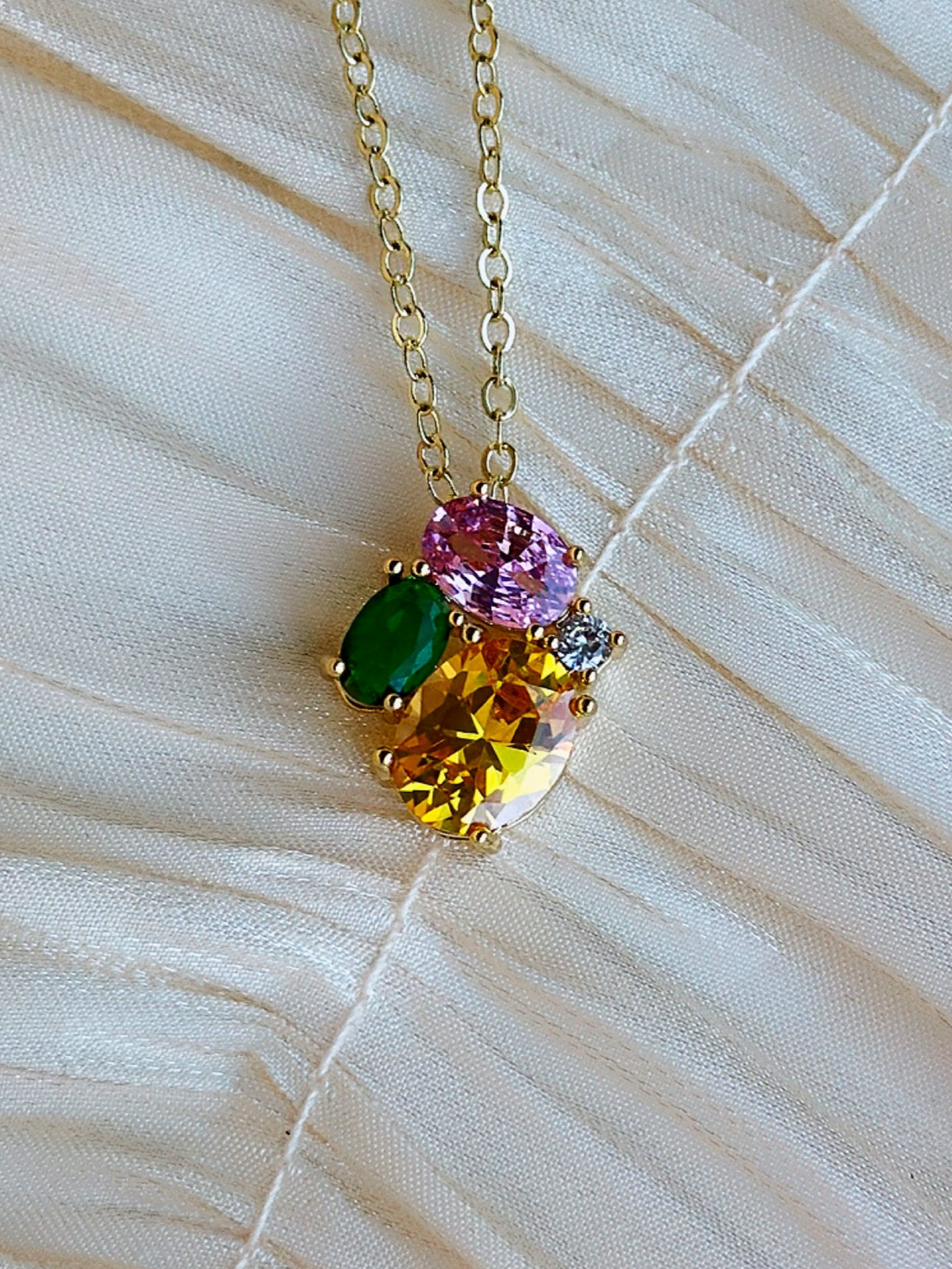 Necklace with multicolored gemstones on a gold-plated chain.
