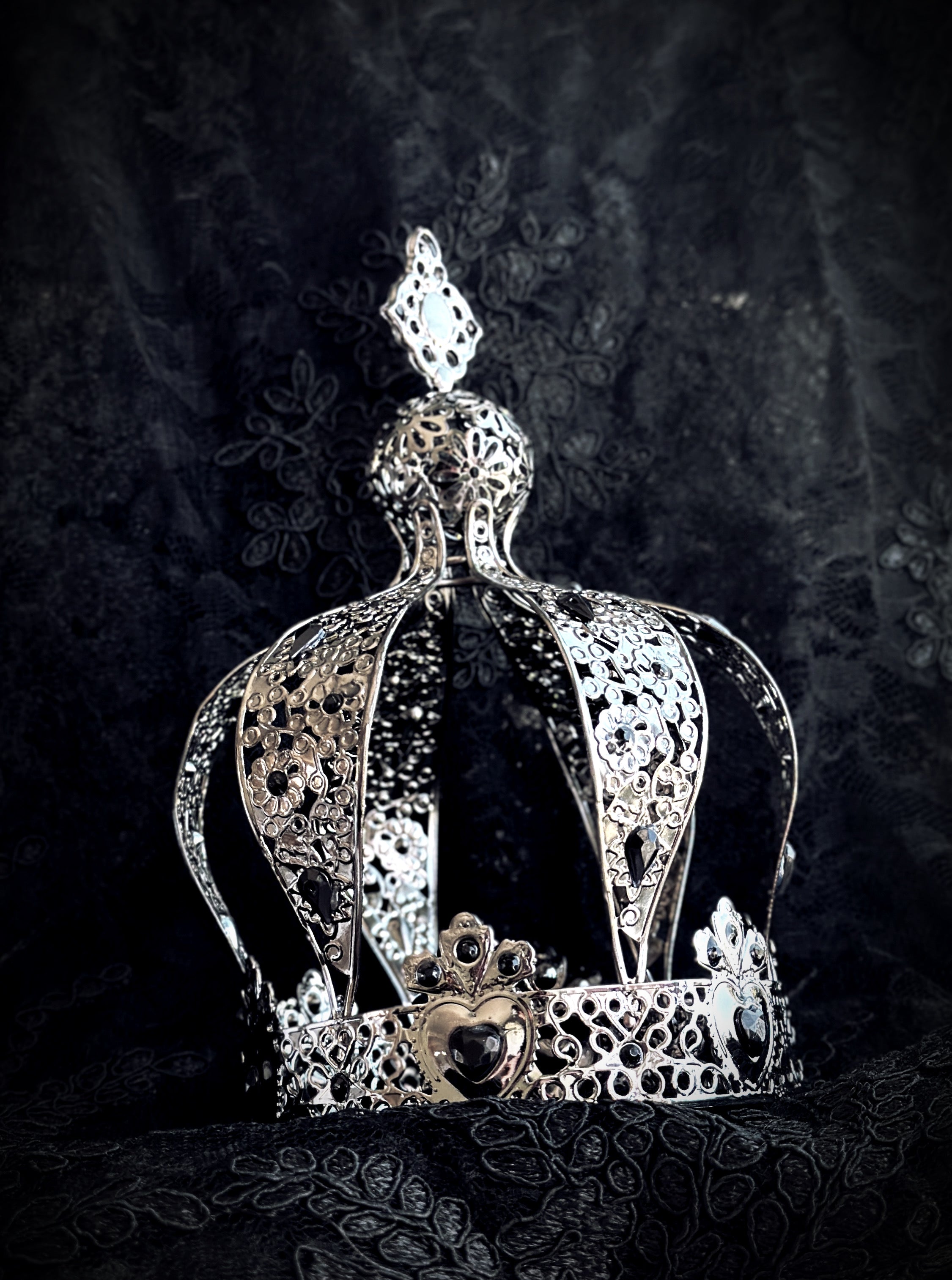 silver gothic crown with filigree hearts and dark gemstone centerpiece