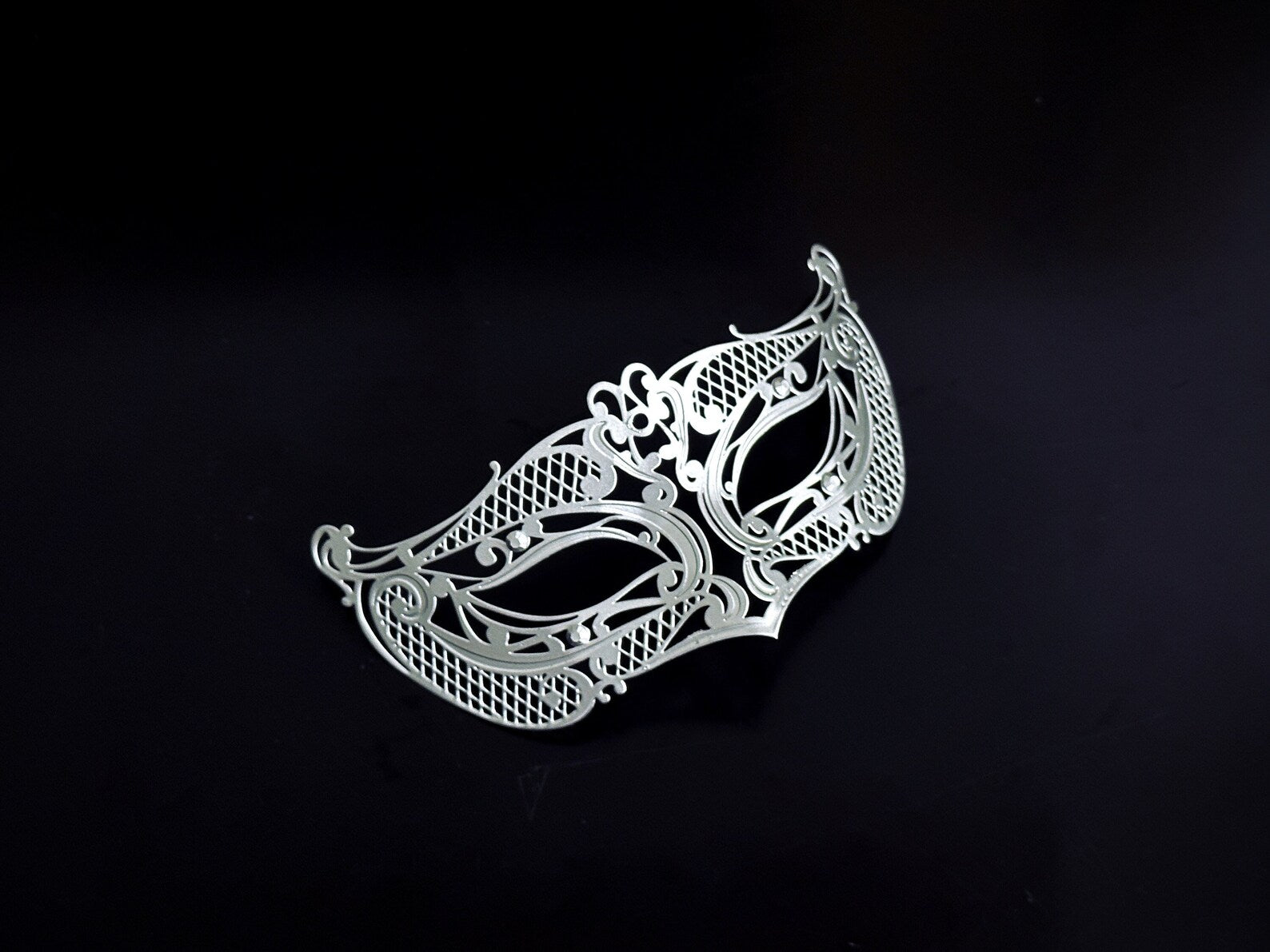 Ornate silver metal masquerade mask for kids with intricate filigree designs, ideal for costume parties and special events.