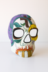 Painted sunflower sugar skull mask for Day of the Dead masquerade.