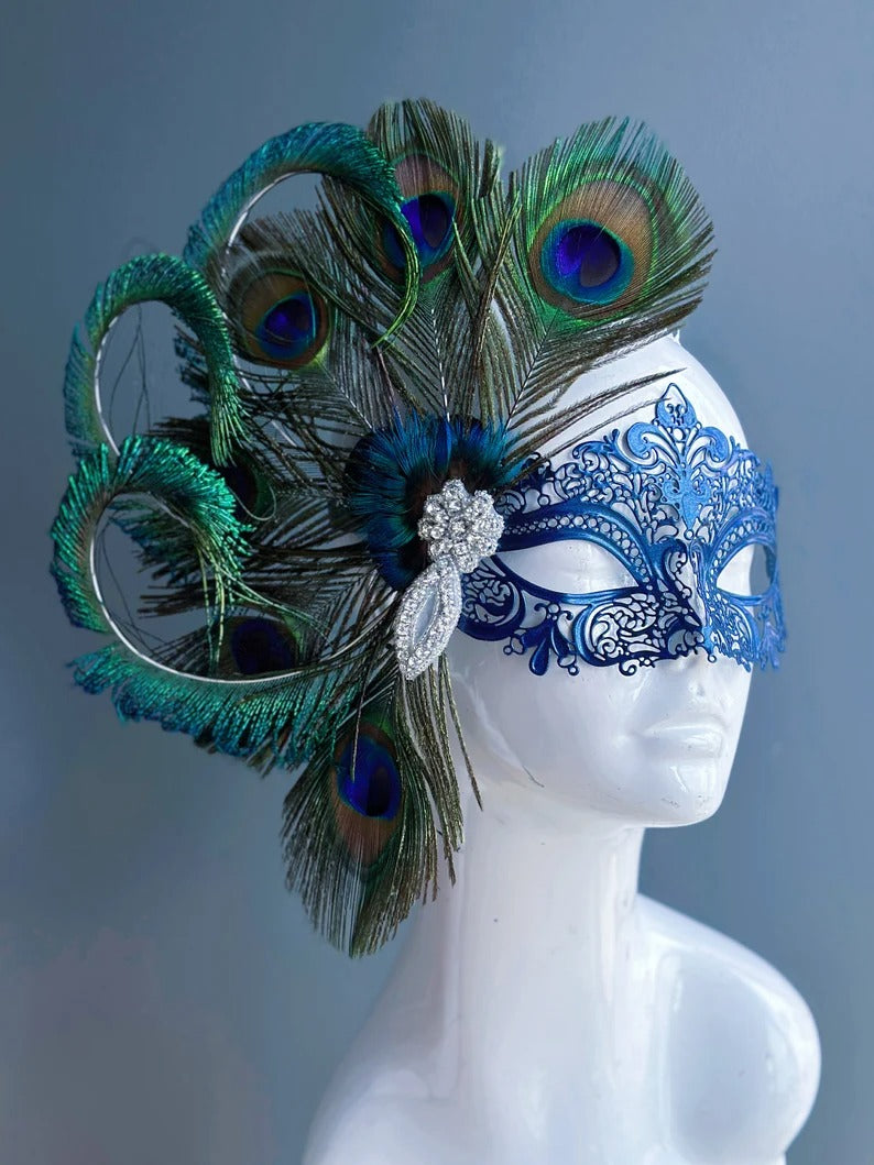 Elegant blue Venetian masquerade mask with peacock feathers and rhinestone accents, perfect for Mardi Gras, prom, weddings, and carnival events.