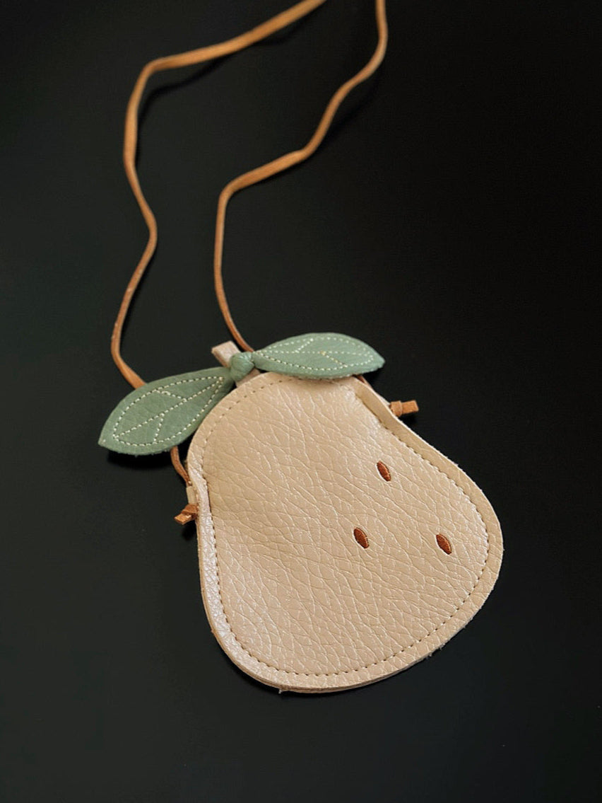 Kids pear-shaped mini bag with green stitched leaves and tan strap, made of soft faux leather.