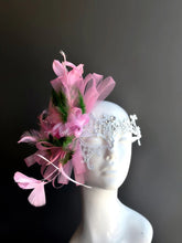 Elegant white lace masquerade mask with pink feathers and rhinestones for women’s prom, carnival, and party looks.