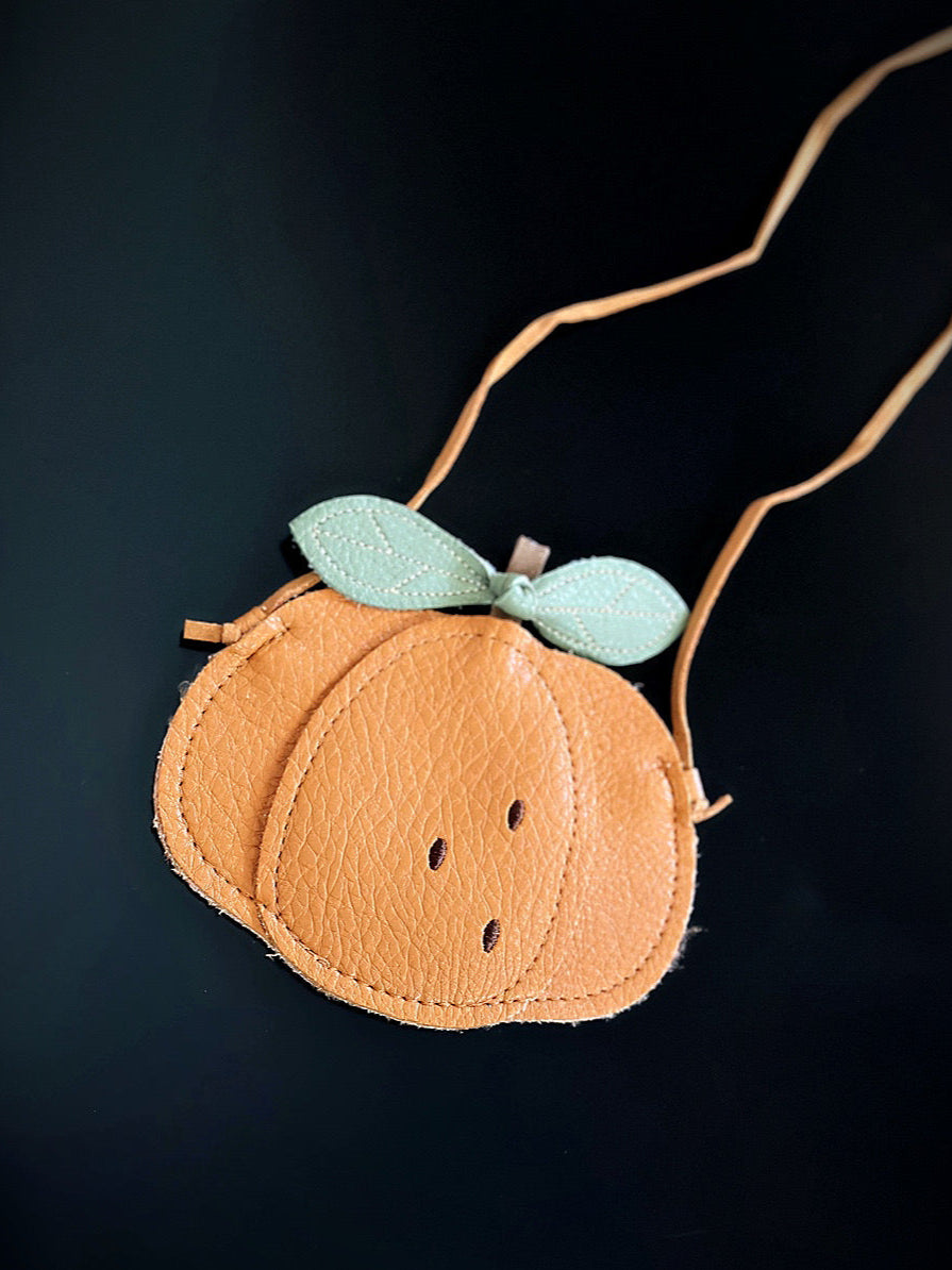 Kids pumpkin-shaped mini crossbody bag with stitched green leaves and tan strap, made of faux leather.
