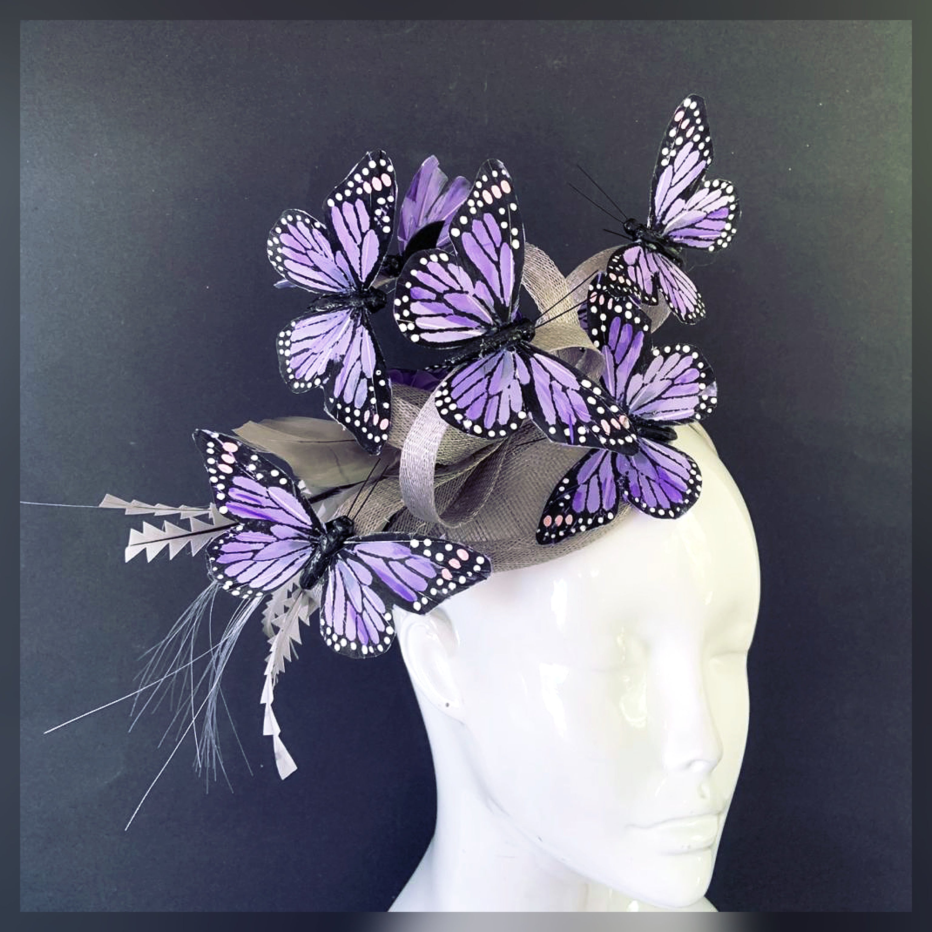 Purple butterfly fascinator on grey silver hat with elegant design