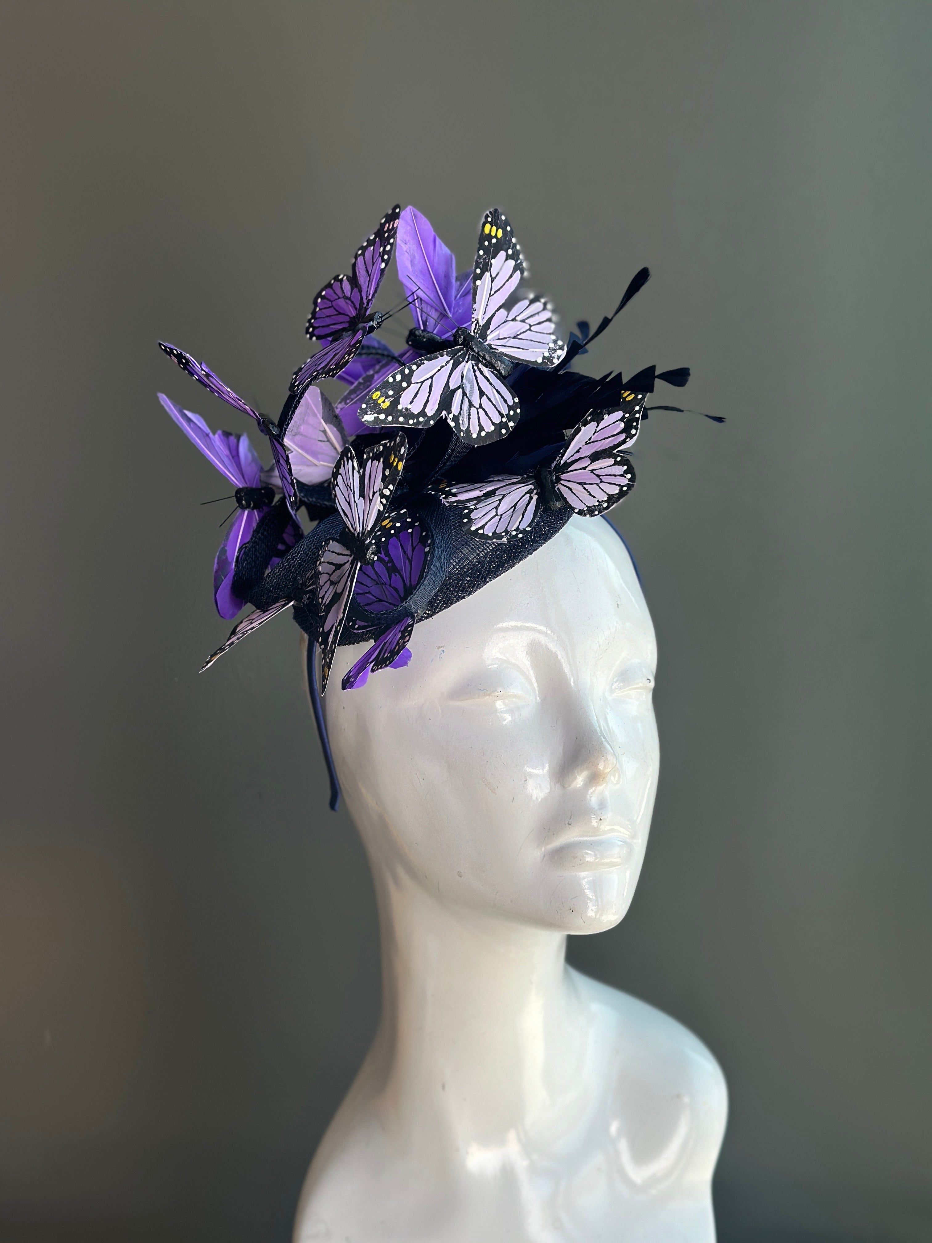 Purple butterfly fascinator hat with delicate butterfly accents, perfect for weddings, garden parties, or races.