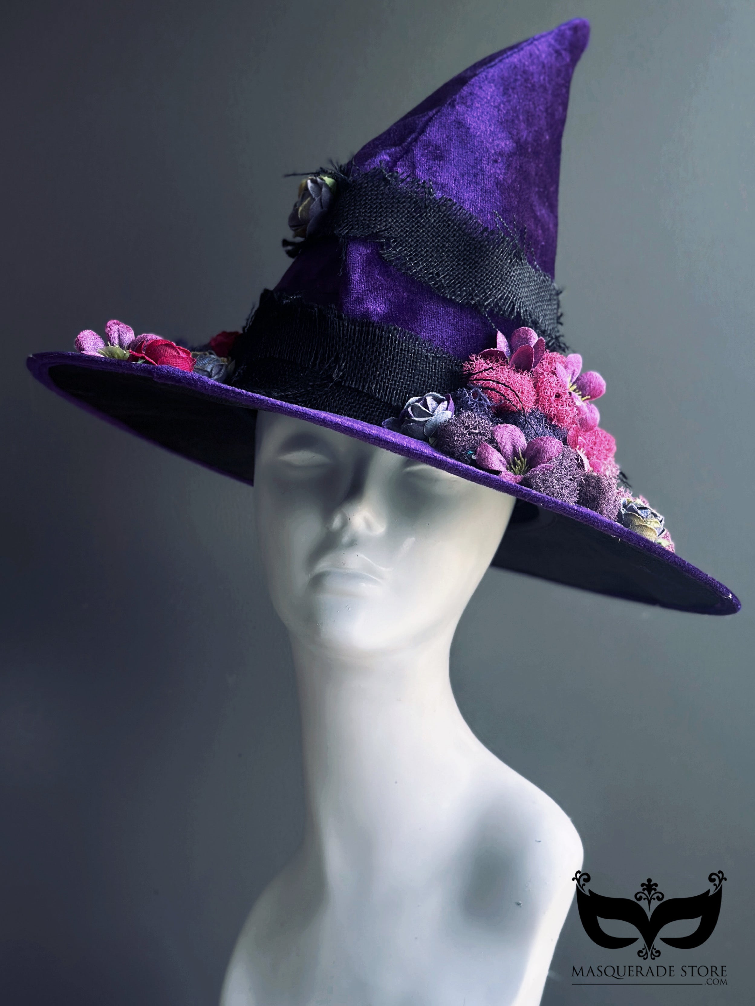 Gothic purple velvet witch hat with black ribbon and deep floral embellishments for Halloween or fall festivals.