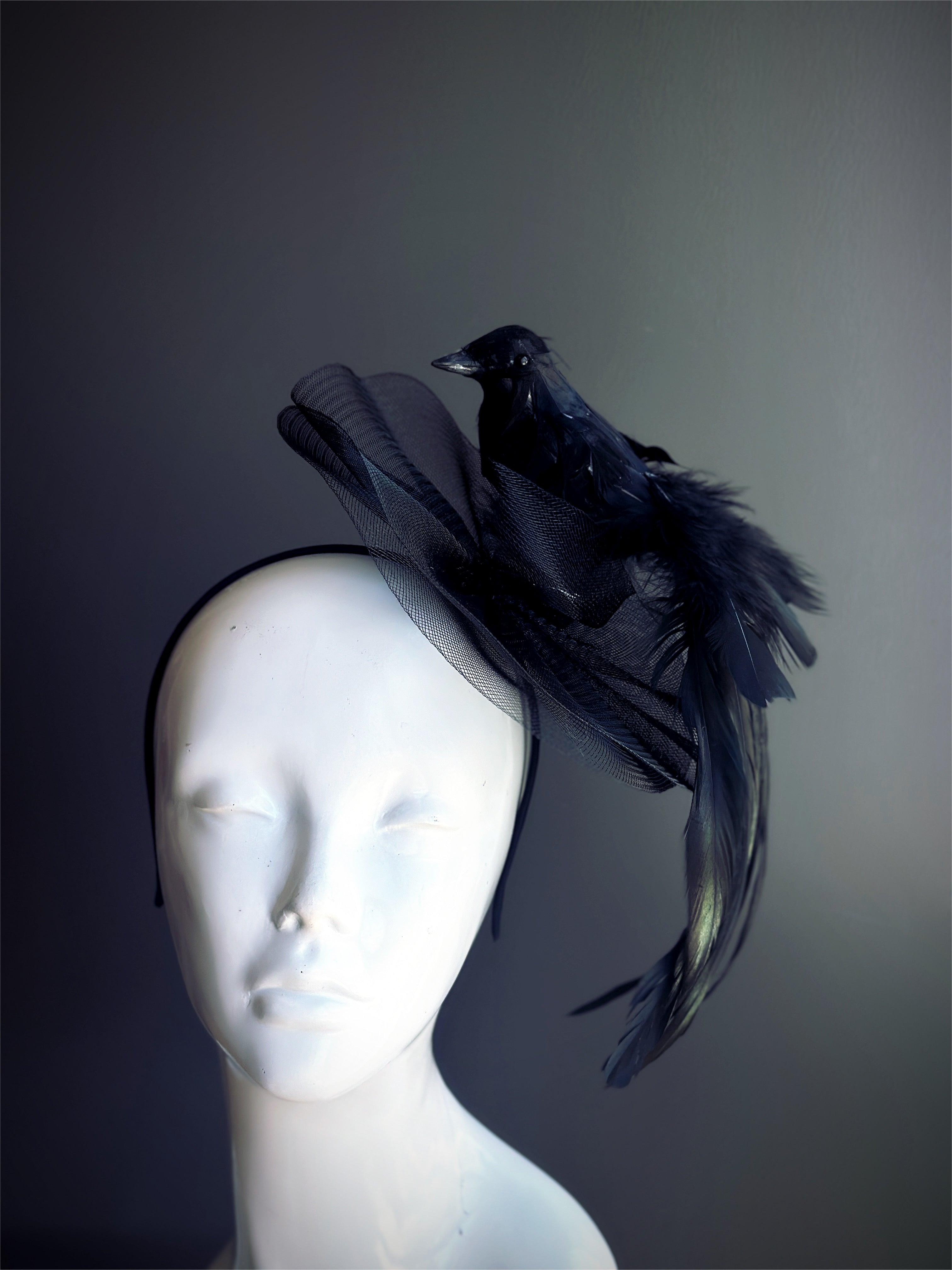 Black fascinator with a raven and feathers, perfect for gothic, Halloween, and statement fashion.
