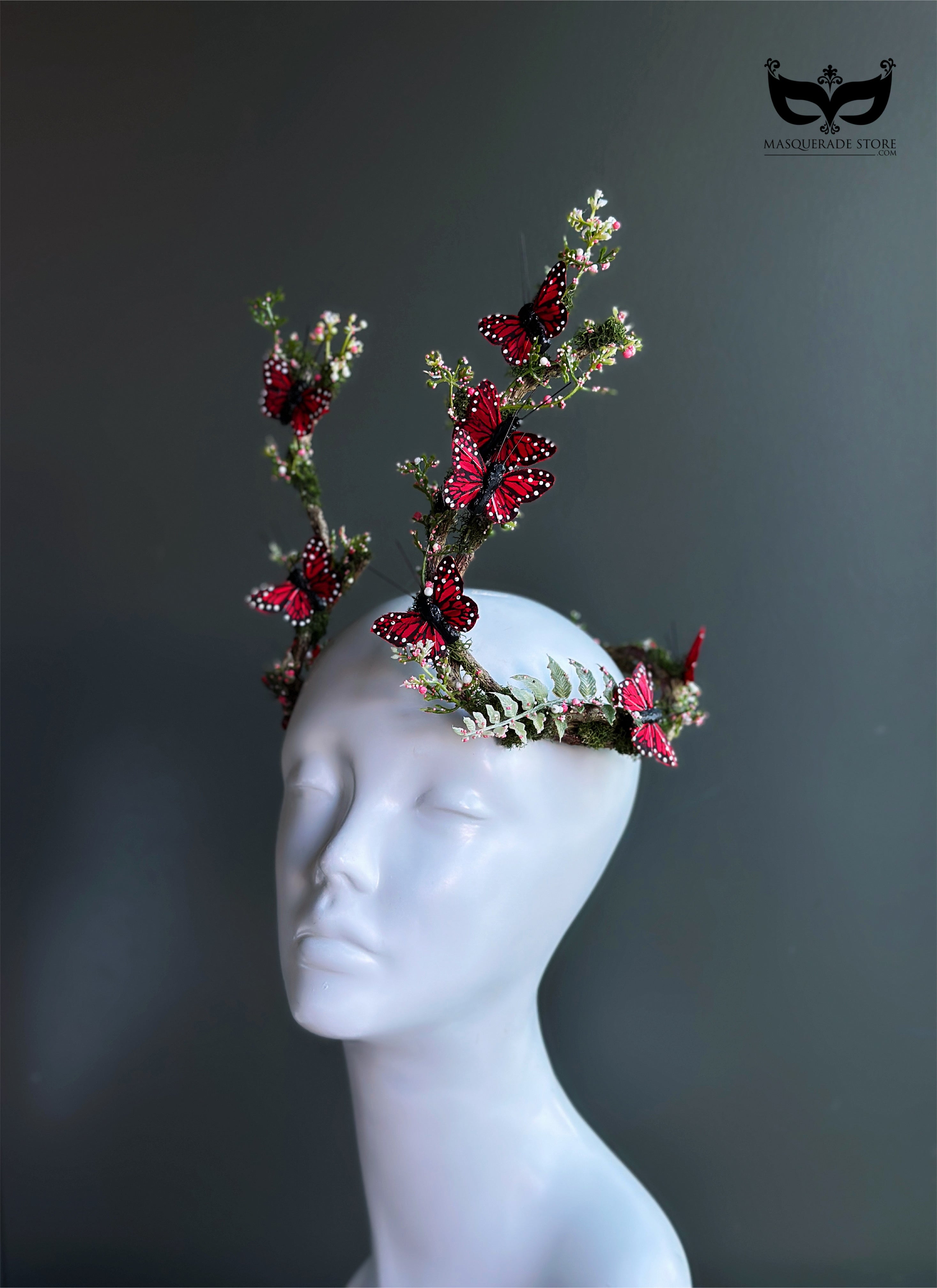 Red butterfly antler headpiece with moss greenery and monarch style wings for fantasy costumes and masquerade events