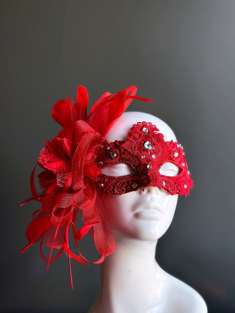 Elegant red lace mask with feathers, rhinestones, and ribbons for Valentine’s, masquerade balls, and prom.