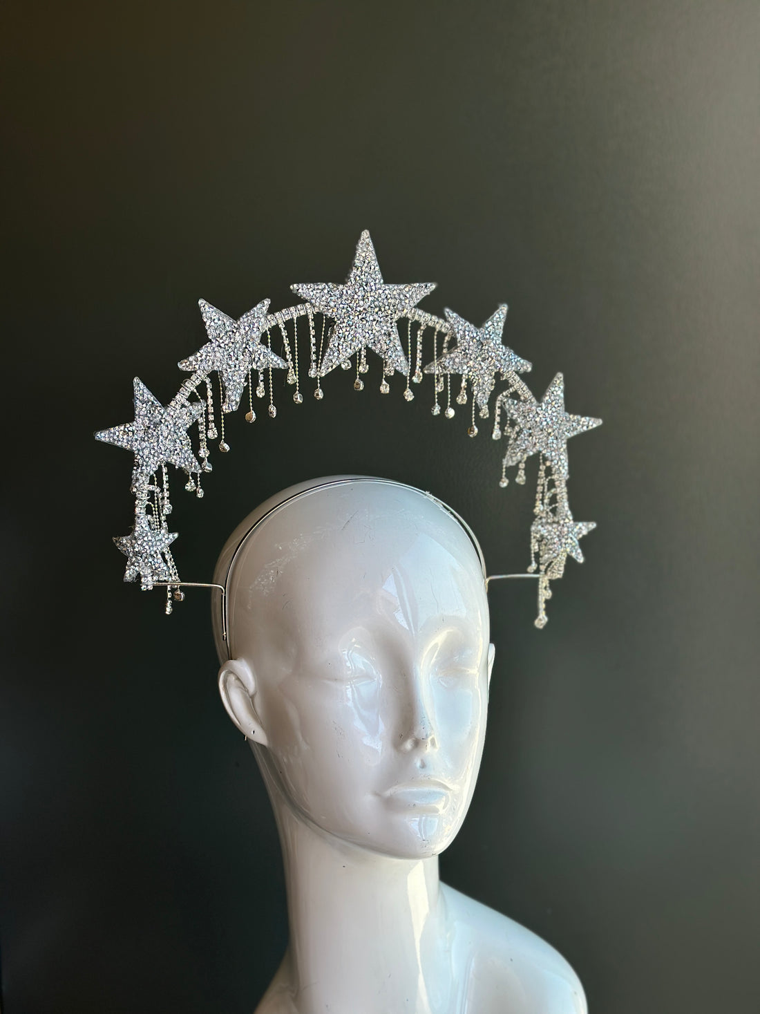 Crystal rhinestone star halo headpiece with dangling gems for celestial-themed costume or event.
