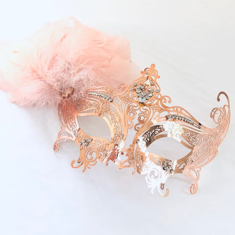 Elegant rose gold masquerade mask with feathers and rhinestones, designed for weddings, Venetian balls, Mardi Gras, and prom parties.