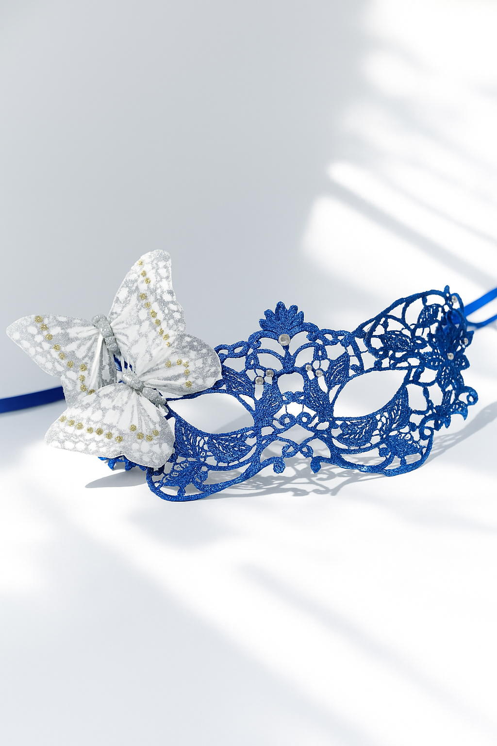 Royal blue lace masquerade mask with silver butterfly accent, elegant lace mask for women, prom, masquerade parties, and costume events.