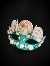 Turquoise masquerade mask with large seashells and pearls in a crown-style design.