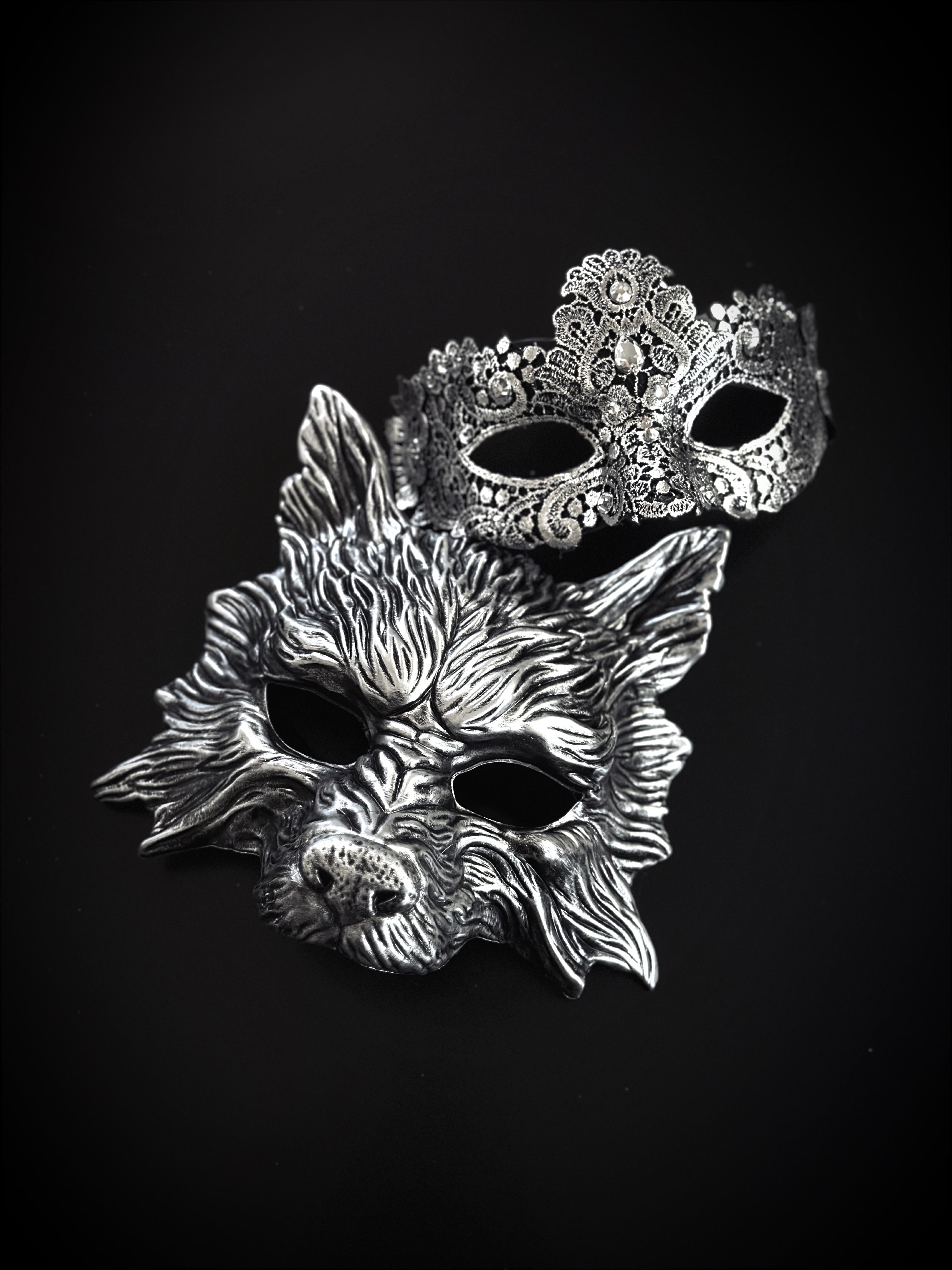 Silver wolf and lace couples masquerade masks on black background