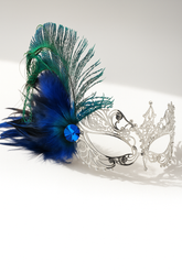 Silver filigree mask with blue and green feathers and jewel accent, designed for masquerade parties, weddings, and proms.