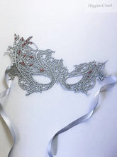 Elegant silver lace masquerade mask with red rhinestones, perfect for proms, formal galas, and Venetian masquerade parties.