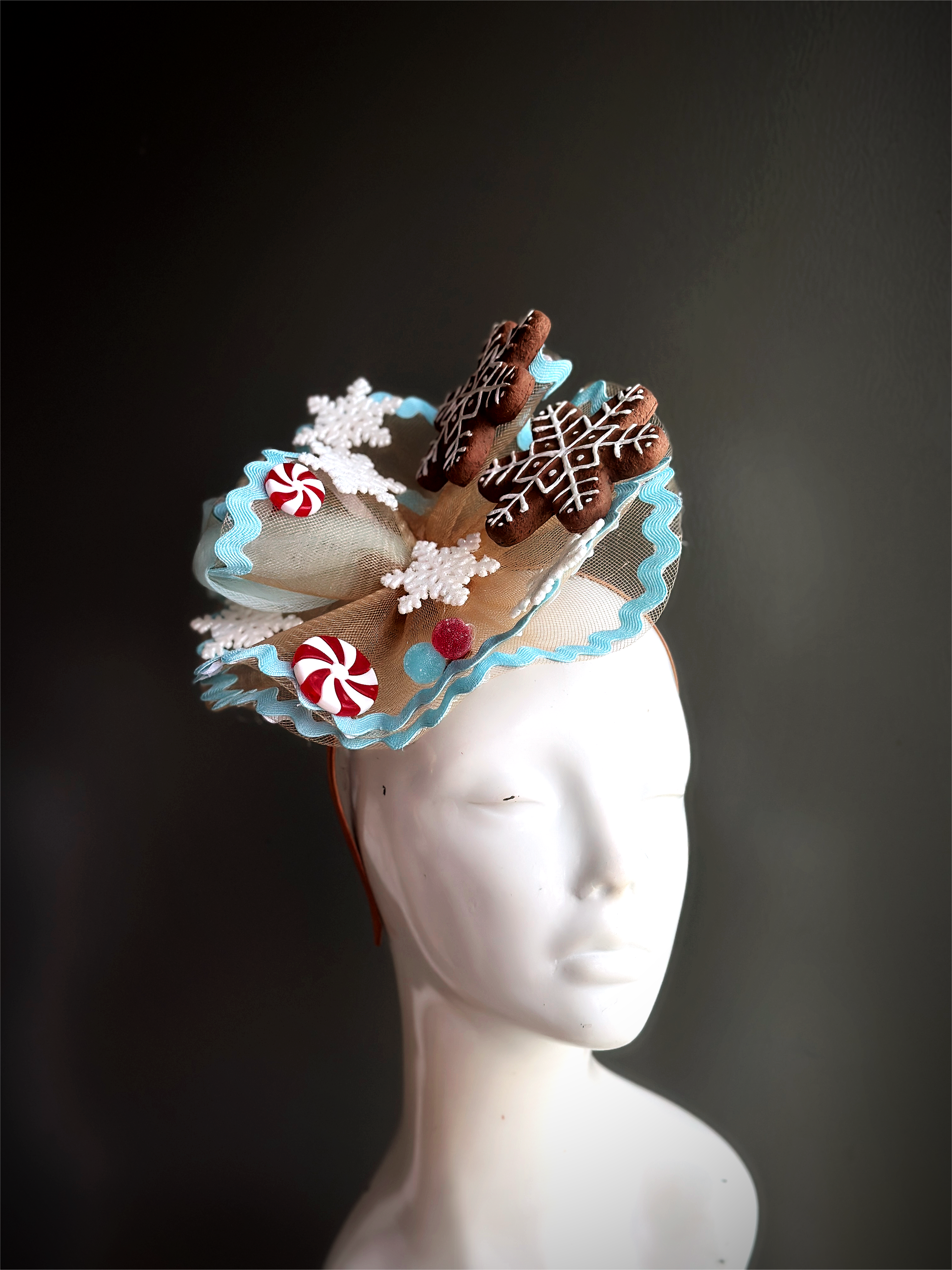 Christmas fascinator with gingerbread snowflakes, candy accents, and snowflake details, ideal for holiday celebrations and events.
