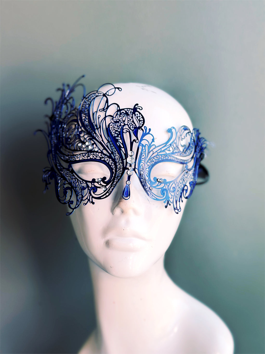 Blue metal mask with swan silhouette, with rhinestones attached