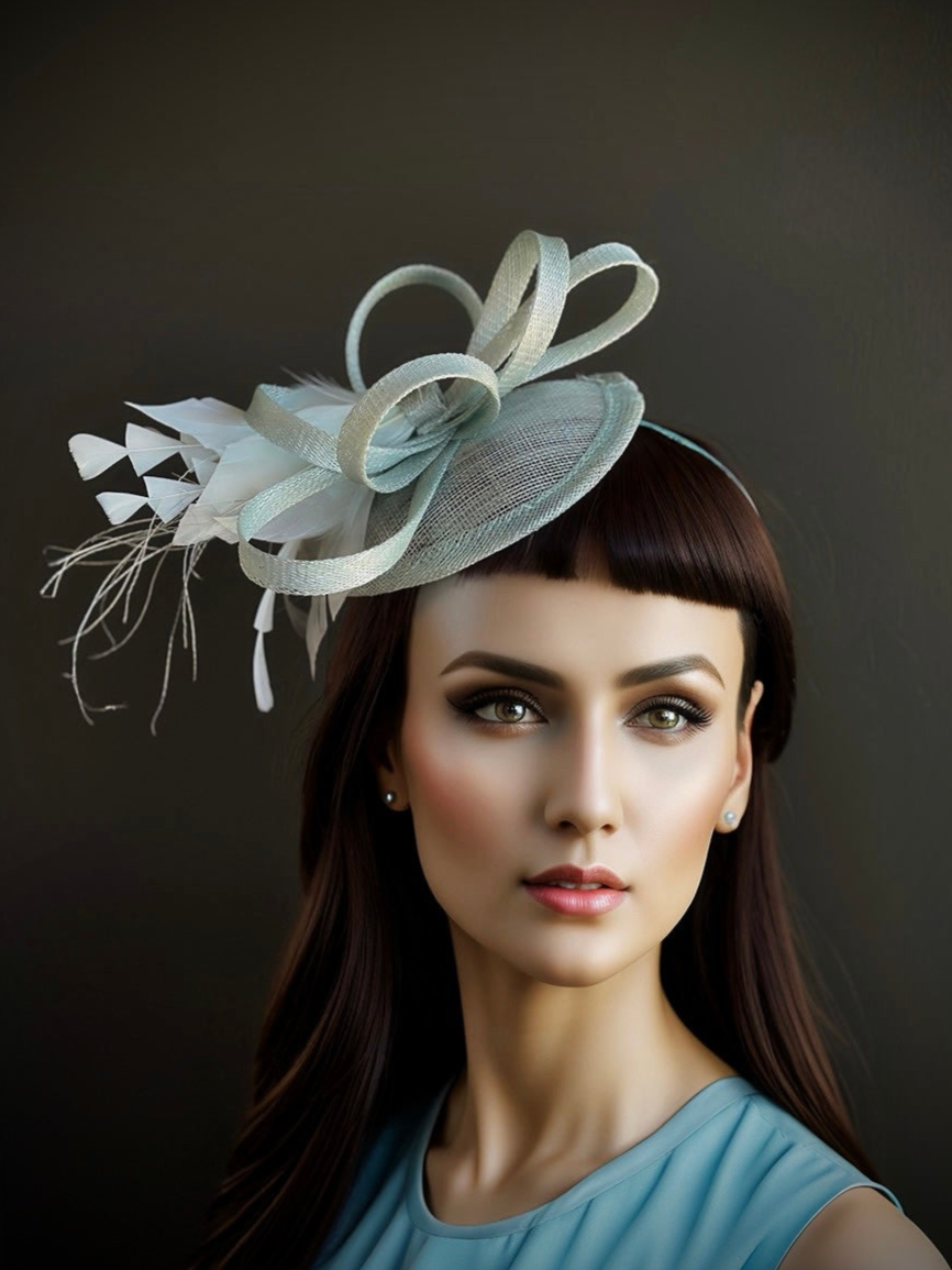 Light blue fascinator hat with sculptural loops and white feathers for tea party or derby