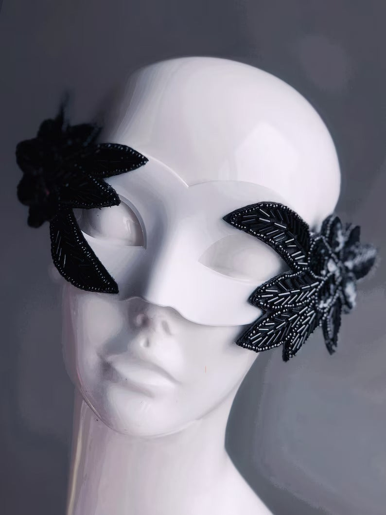 Nocturne Bloom white masquerade mask with black beaded floral accents, perfect for modern masquerade parties.