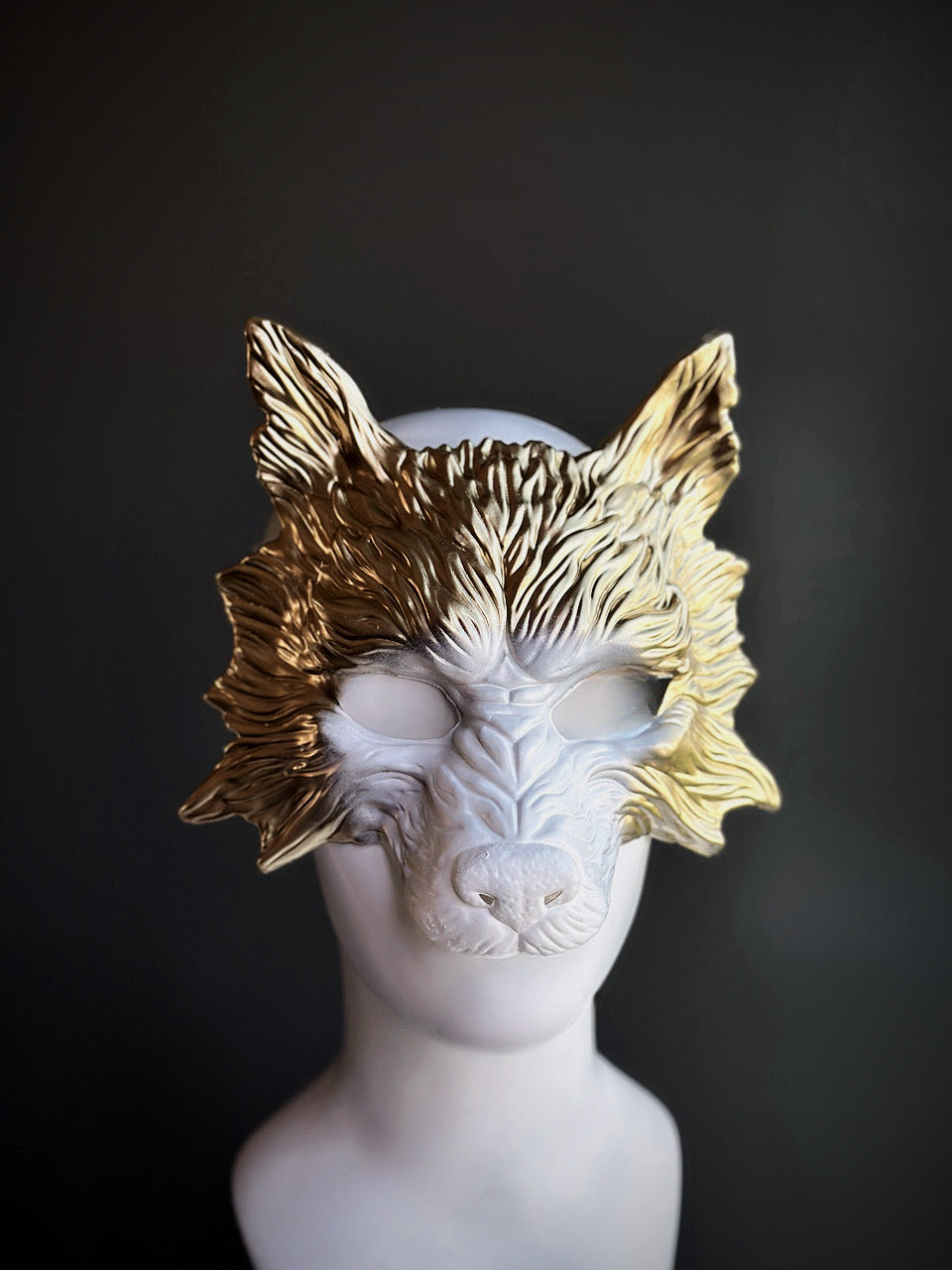 White werewolf mask with sculpted fur details and gold accents on the upper portion, perfect for Halloween and fantasy-themed events.