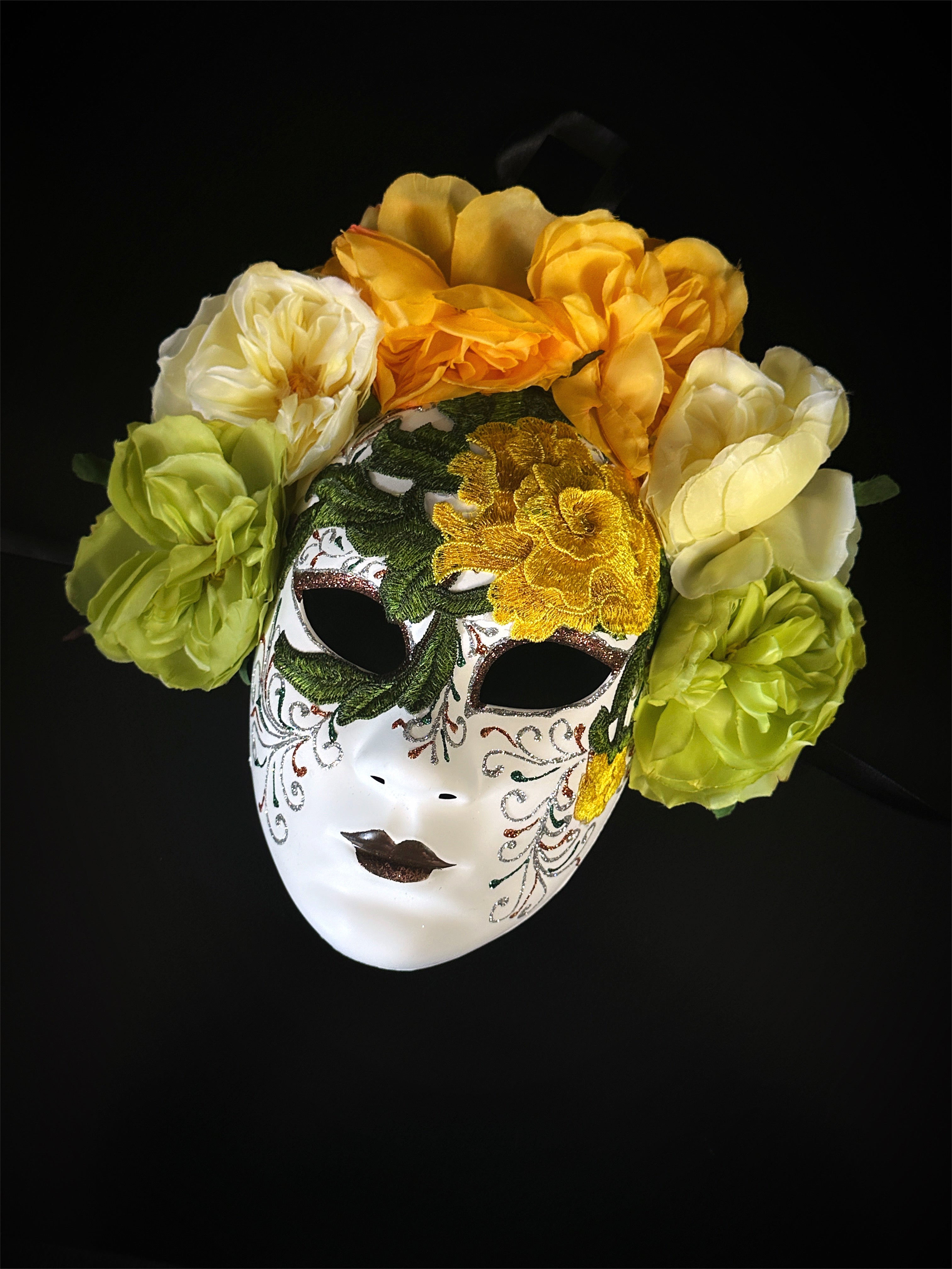 Yellow and green floral mask with embroidered detailing, featuring large blooming flowers, inspired by Venetian craftsmanship