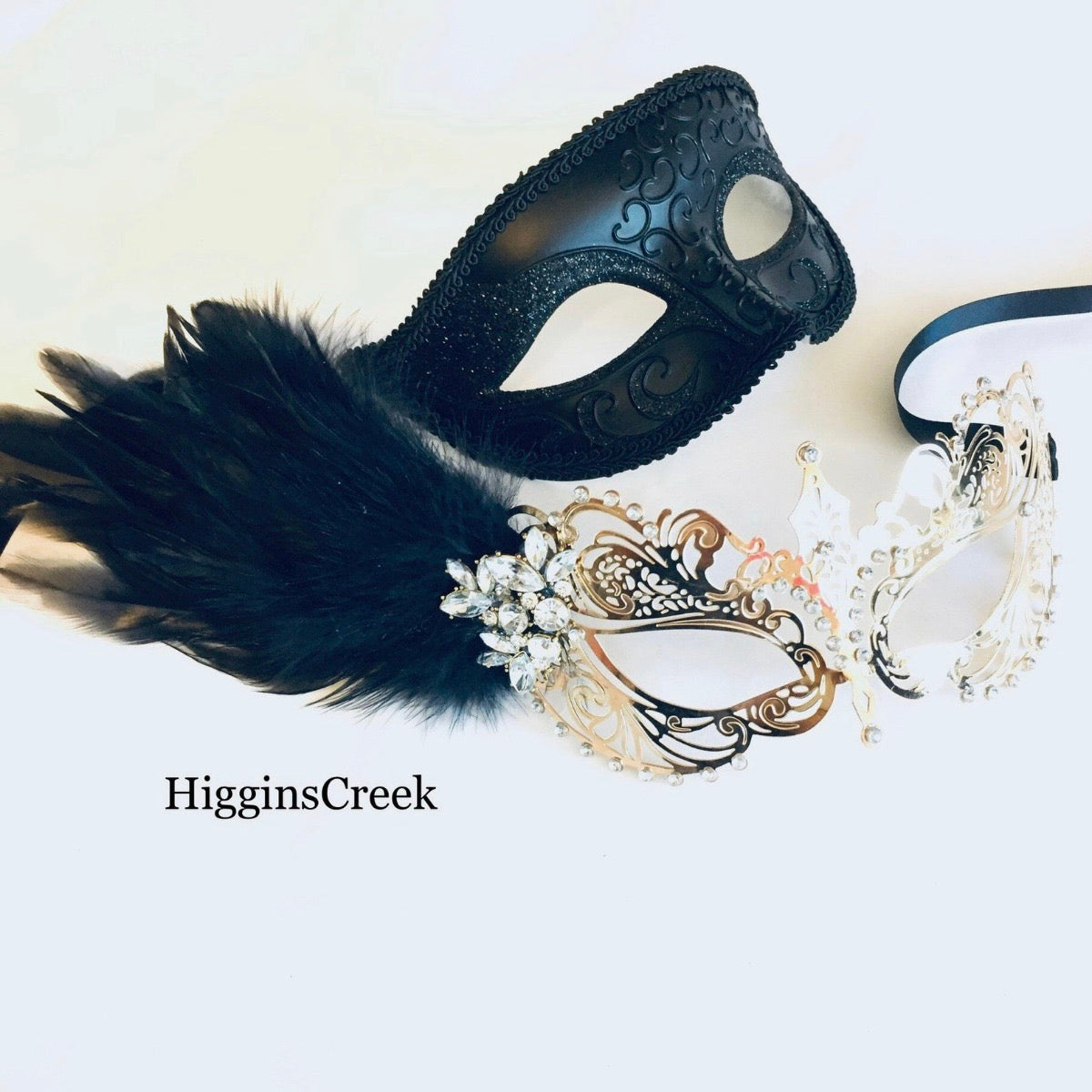Elegant feathered masquerade mask set for couples in black and gold or silver
