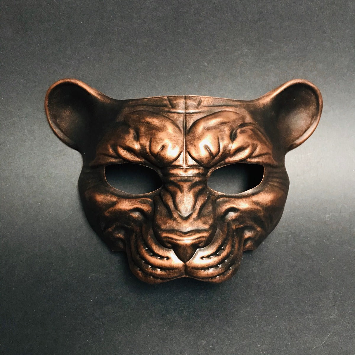 Metallic copper animal face mask with panther shape for jungle or fantasy masquerade events