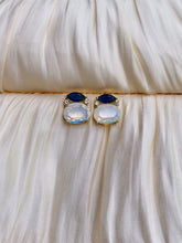Blue and opal white gemstone stud earrings with gold setting and marquise top stones.