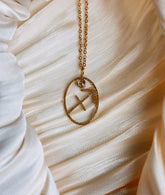 gold sagittarius zodiac pendant necklace with a yellow gemstone