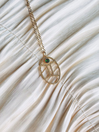 gold gemini zodiac pendant necklace with emerald gemstone