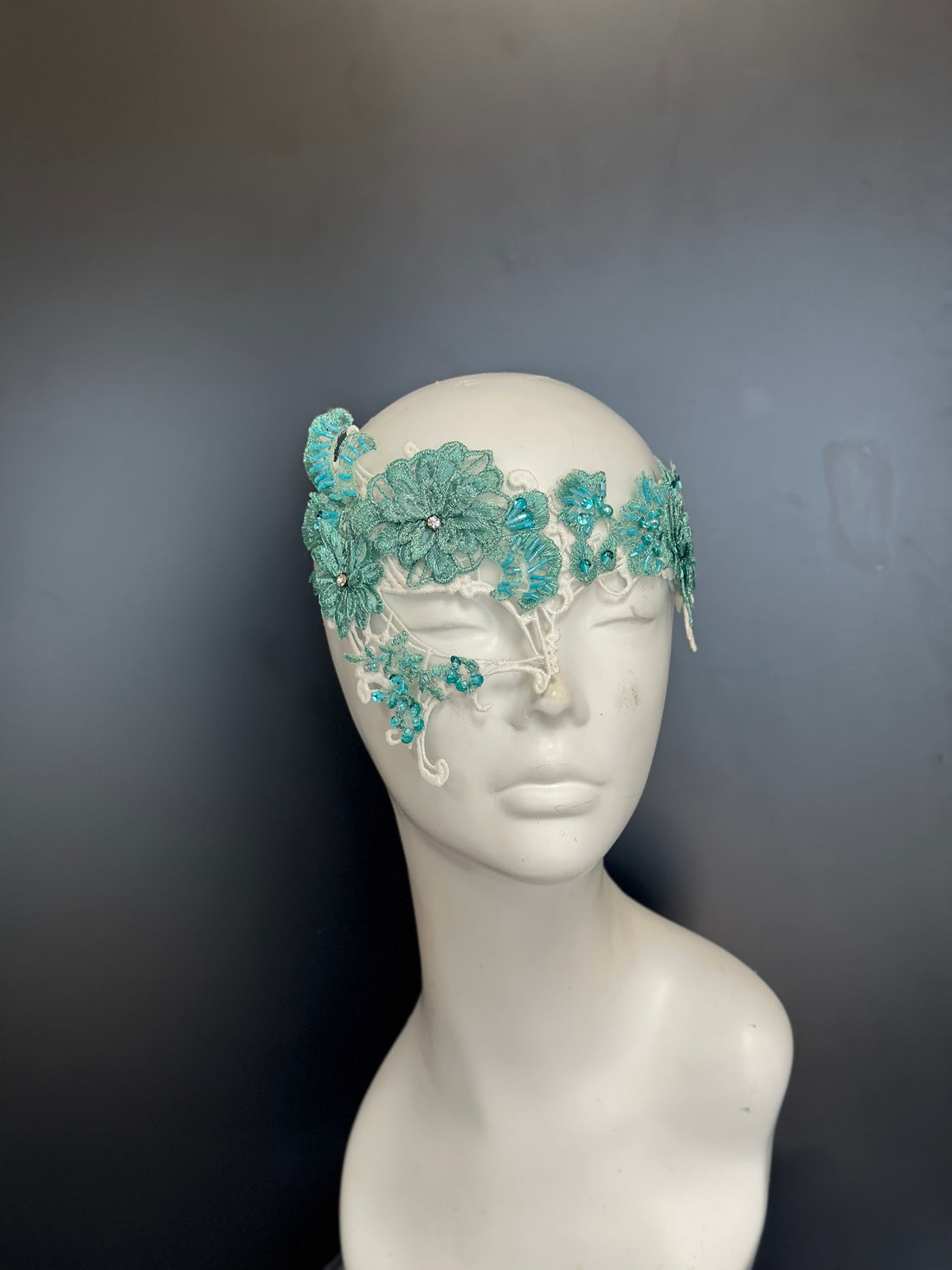 Aqua floral lace masquerade mask with rhinestones and embroidered design for elegant events.