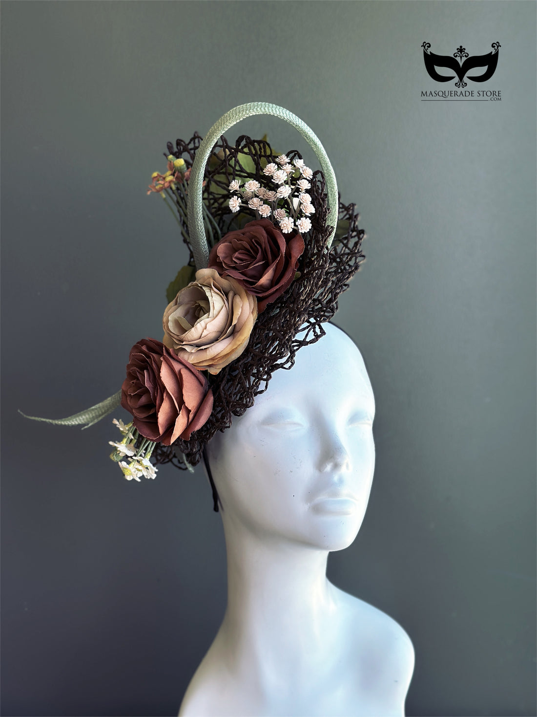 Brown taupe and sage floral fascinator with layered autumn roses, ivory blossoms, sculptural loops, foliage, and dark woven openwork base.