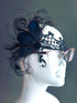 Peacock feathers with intricate black lace, designed to fit comfortably over glasses. 