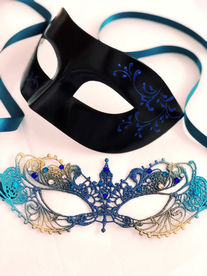 Couple’s masquerade mask set with a teal and gold lace rhinestone women’s mask and a sleek black men’s mask with blue scrollwork.