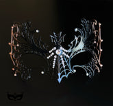 Black and bronze spiderweb masquerade mask with metal filigree openwork, crystal accents, winged gothic details, and Halloween styling.