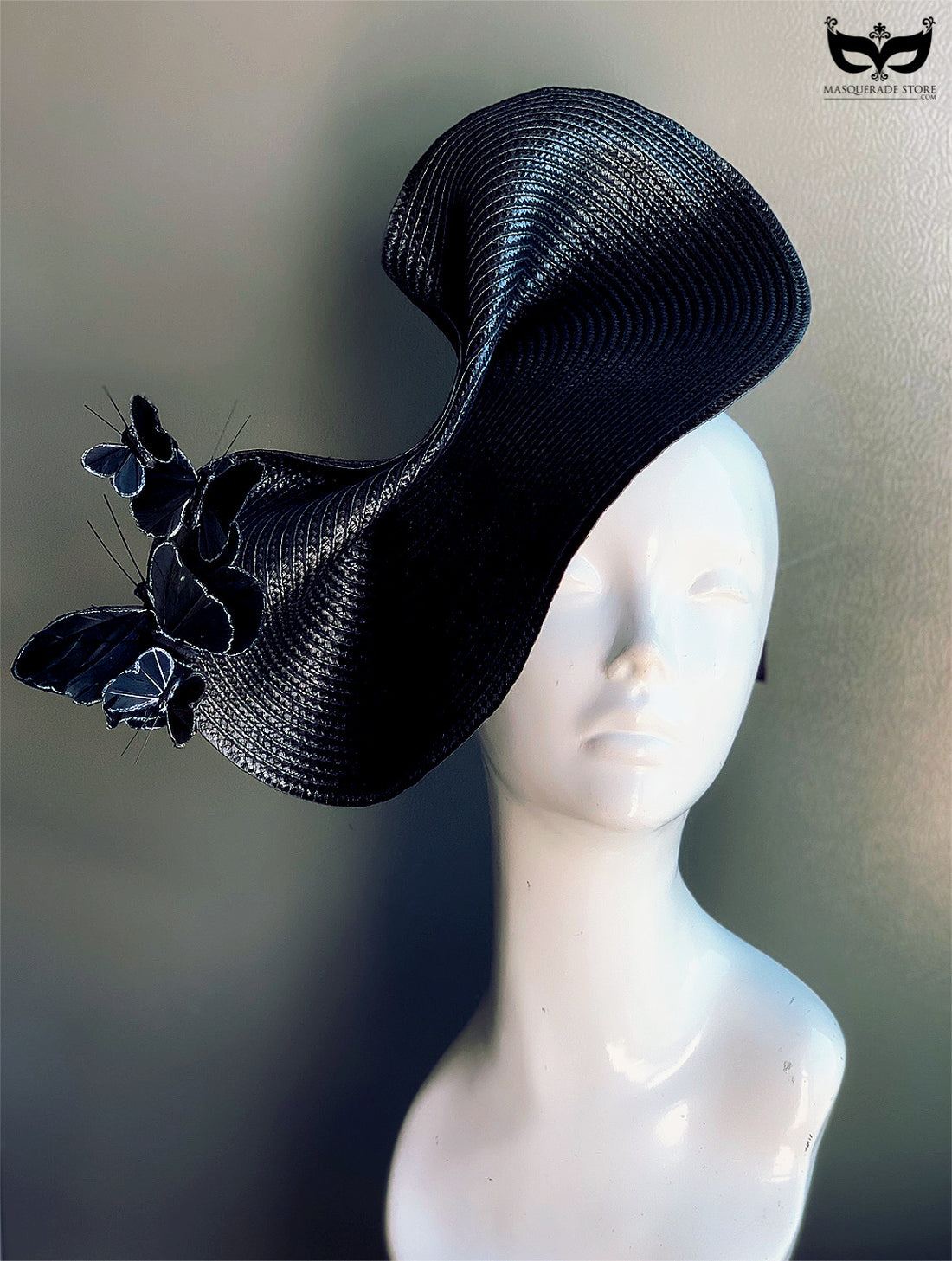 Black fascinator hat with sculptural curves and butterfly accents, perfect for Derby, weddings, races, and masquerade events.