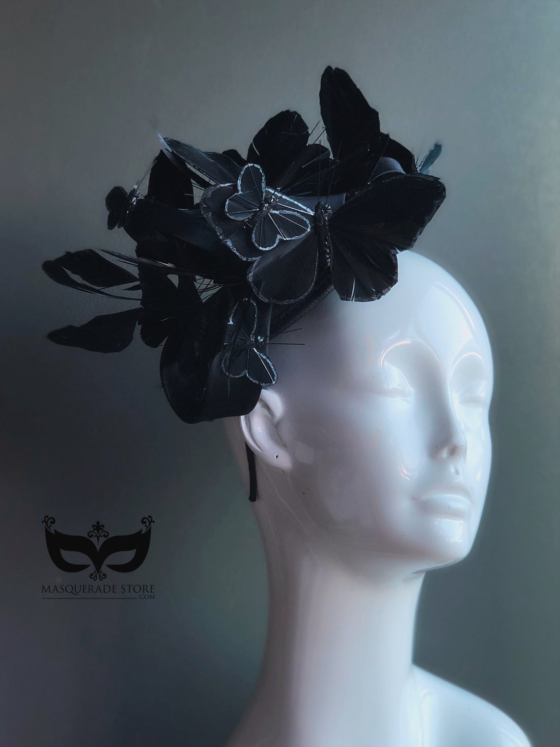 Black butterfly fascinator hat with layered butterflies and feathers for gothic masquerade or Halloween look.