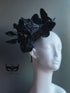 Black butterfly fascinator hat with layered butterflies and feathers for gothic masquerade or Halloween look.
