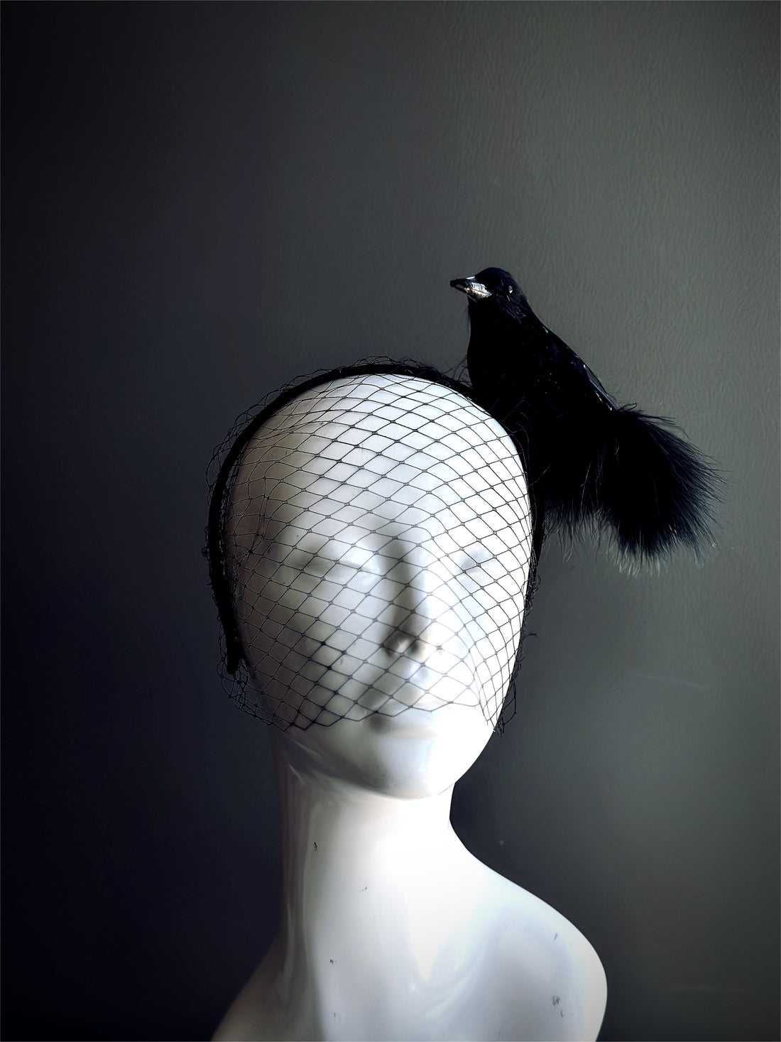 Black crow fascinator with mesh veil for gothic masquerade, witch costume, or Halloween outfit