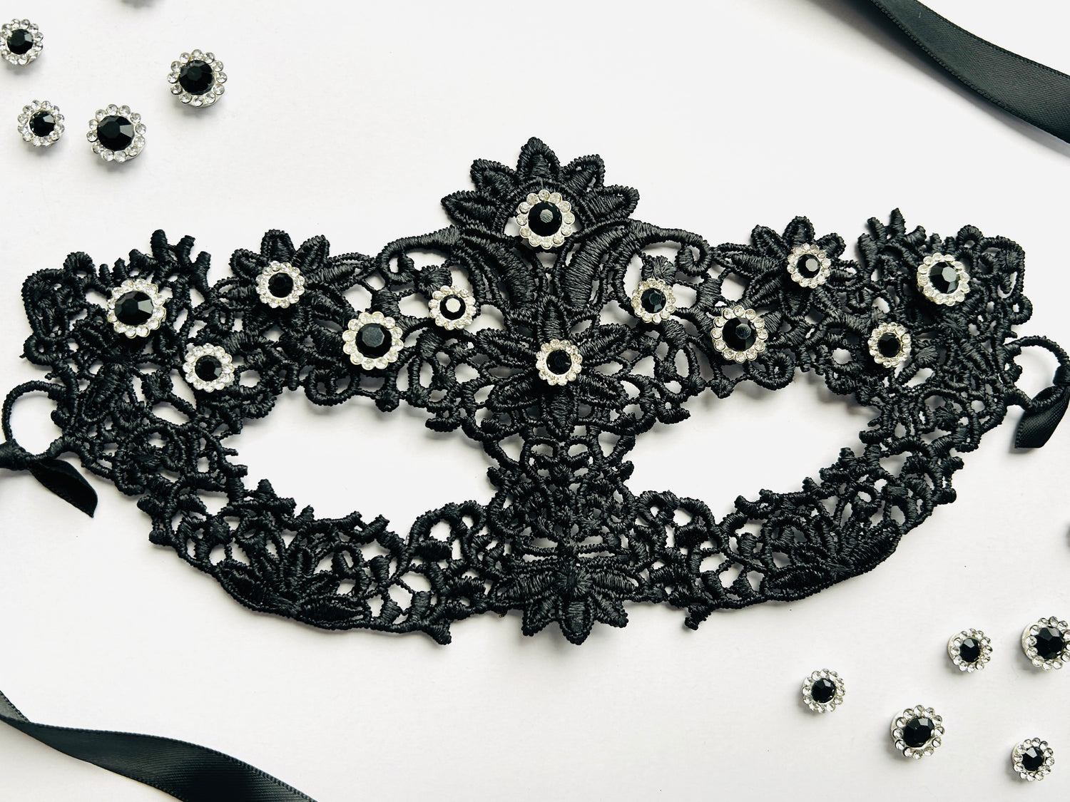 Black lace masquerade mask with black crystal rhinestones for moon ball and formal gala events.
