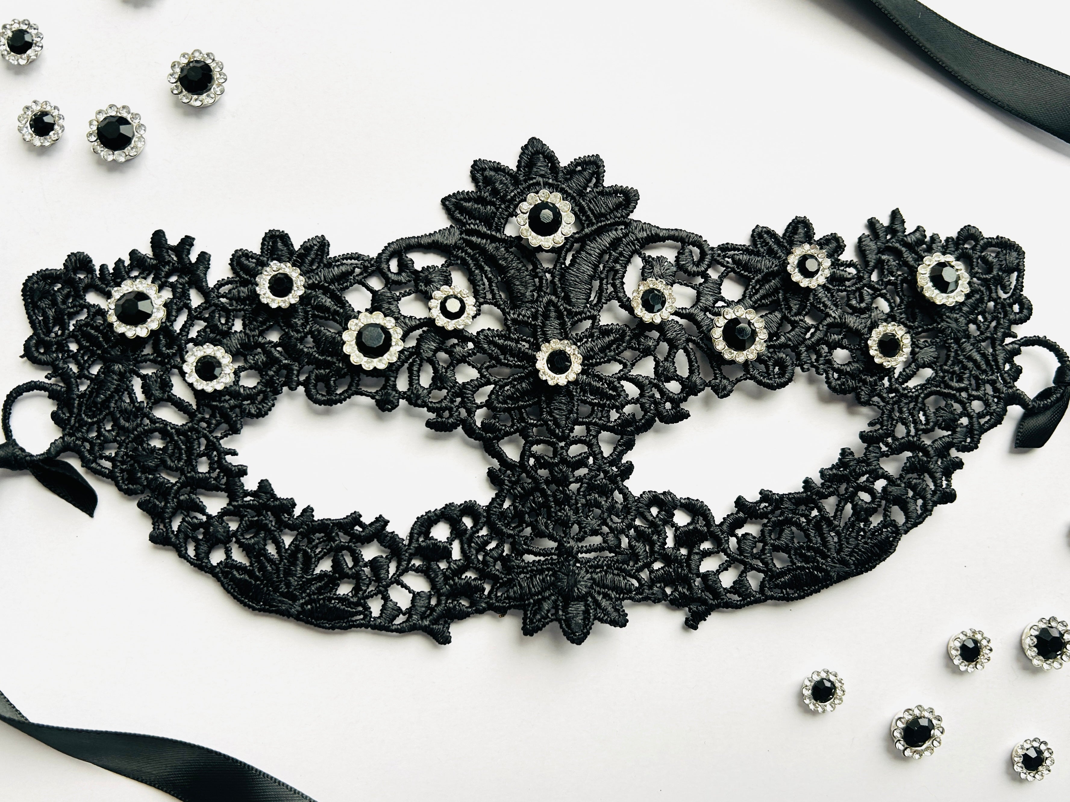 Black lace masquerade mask with black crystal rhinestones for moon ball and formal gala events.